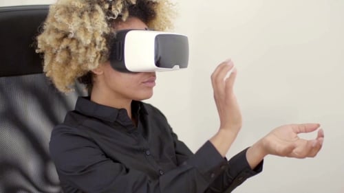 Woman in VR Goggles Interacting in Virtual Reality