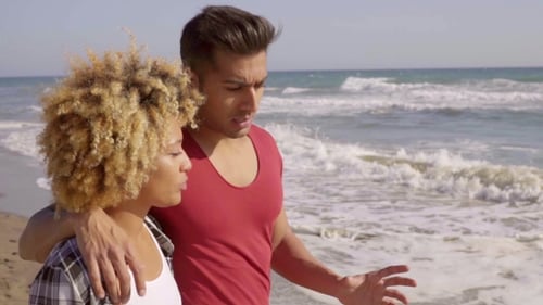 Young Mixed-Race Couple Standing On The Beach