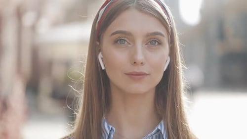 Stylish Woman with Headband and Wireless Earbuds