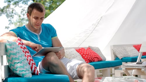 Man using Tablet on Park Bench