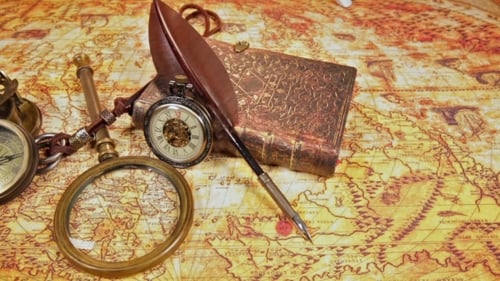 Antique Compass, Pen and Book on Vintage Map