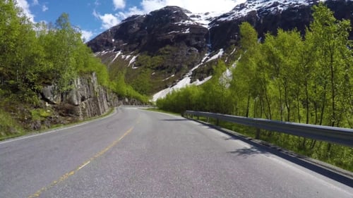 Driving a Car On a Serpentine Road In Norway