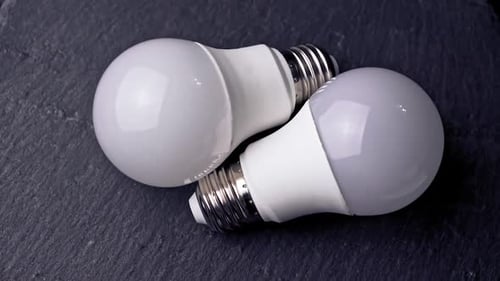 Energy saving light bulb on a black background.