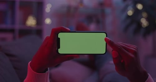 Man Doing Scrolling Gesture on Green Mobile Screen