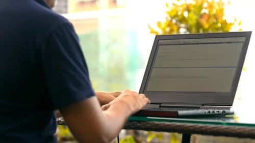 Website Developer Focuses on Codes Works at Laptop