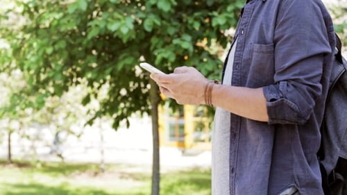 Man With Backpack Texting On Smartphone In City 39