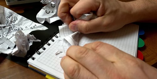 People Tearing the Sheet of Paper