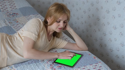Beautiful Girl Using Tablet PC with Pre-Keyed Green Screen