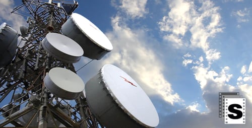 Telecommunications Tower Against Blue Sky and Clouds
