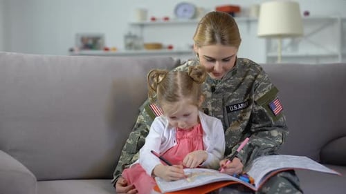 Soldier and Child Coloring Together at Home