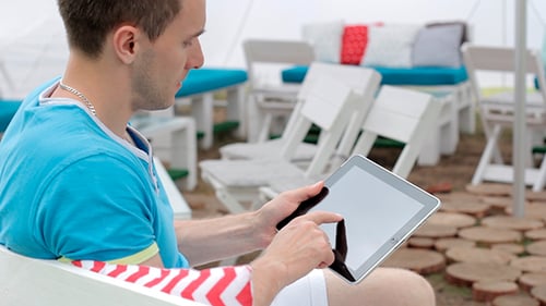 Young Adult Male Using Tablet Outdoors