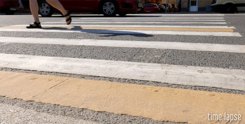 Busy Urban Crosswalk with Cars and Pedestrians