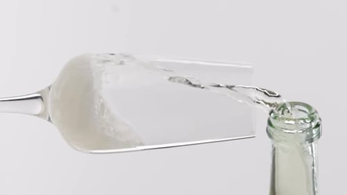 Vertical video, Close-up of sparkling champagne being poured into a glass; bubbles in a glass