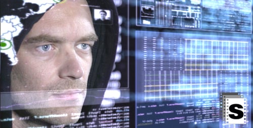 Man Looking At Computer Code on Digital Screens