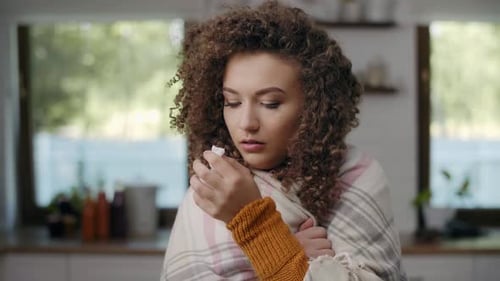 Woman With Cold Holding Tissue Indoors