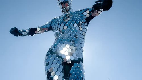 Mirrored Costume Performer Dancing Under Blue Sky