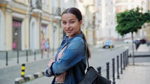 Smiling Woman Poses on City Street