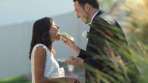 Bride and Groom Share Cake on Wedding Day