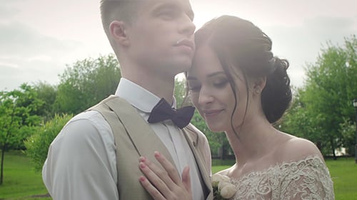 Loving Couple Embrace in Park on Wedding Day