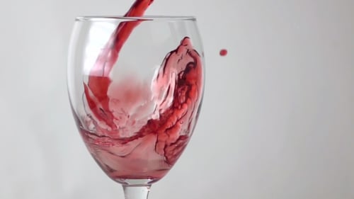 Red Wine Pouring Into Glass in Close Up