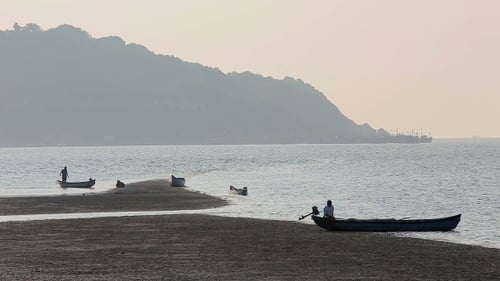 Misty Tropical Seascape With Boats And Fishermen Silhouettes