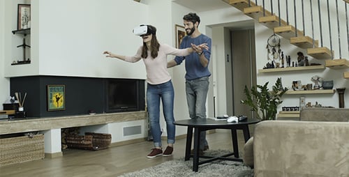 Woman Explores Virtual Reality with Partner at Home