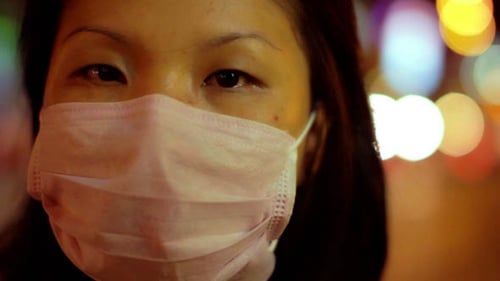 Chinese Girl Cover Her Face with Mask at Night