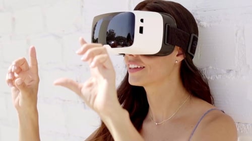 Woman with VR Headset Using Hand Gestures