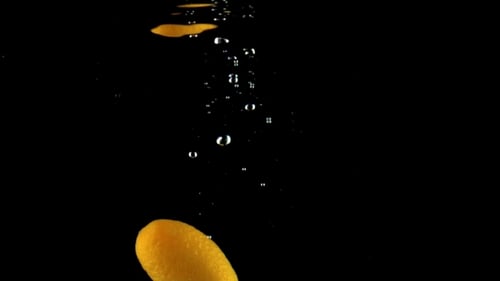 Single Orange Kumquat Falls Under Water