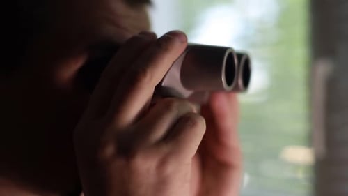 Close Up of Person Looking Through Binoculars