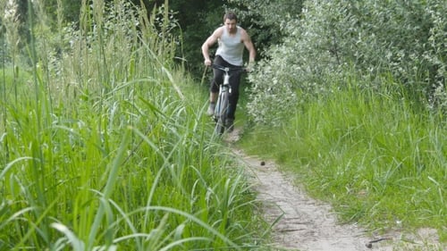Young Men Biking on Rural Dirt Path