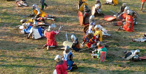 Medieval Reenactment with Armored Adults on Grassy Field