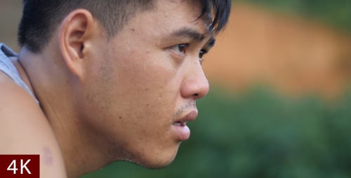 Asian Man Jogger Taking A Break