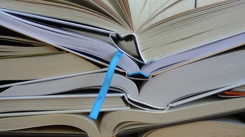 Stacked Open Books with Colorful Bookmarks