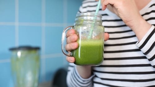 Female Tasting a Green Smoothie