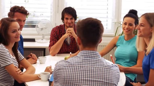 Team Discussing Ideas Around Table in Modern Office