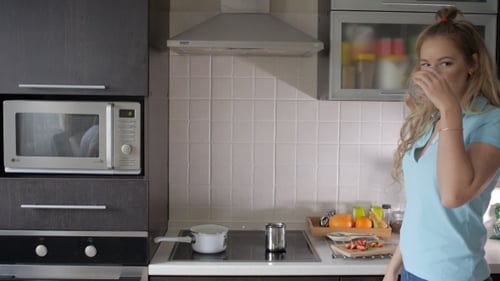Woman Preparing Food in Modern Kitchen