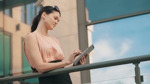Woman With Tablet Pc In a Front Of Office Building