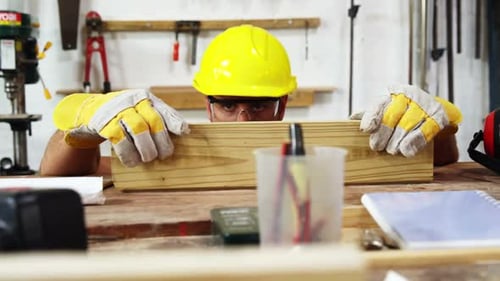 Carpenter working on his craft and smiling for camera