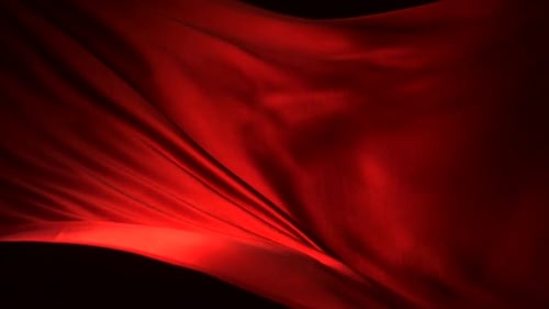 Red Silk Fabric Flowing Elegantly Against Black