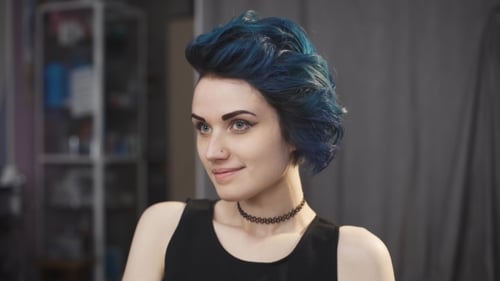 Woman with Blue Hair Smiling Indoors