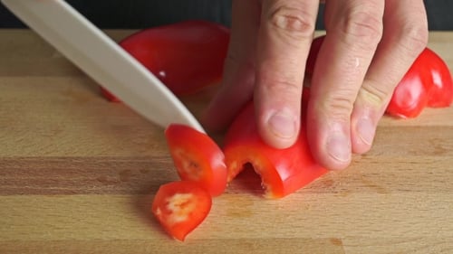 Slicing Fresh Red Pepper on Cutting Board