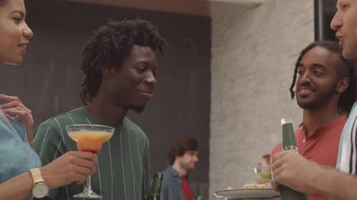 Young Diverse Friends Clinking Glasses during Summer Party on Terrace