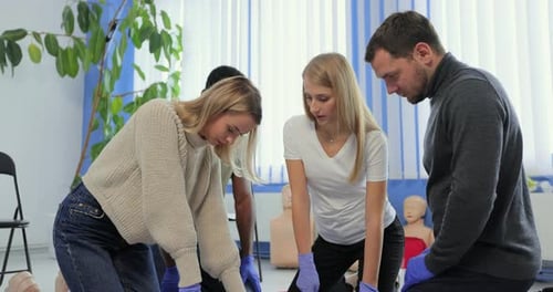 CPR Training with Mannequins in Bright Room