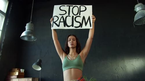 Young Woman Holding 'Stop Racism' Sign