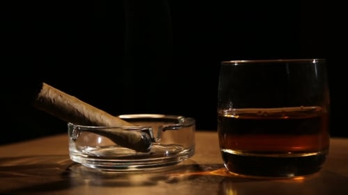 Whiskey and Smoking Cigar on Table