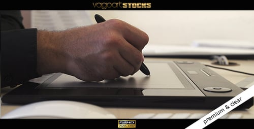 Man Hand Using Stylus Pen on Graphics Tablet