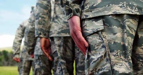 Military Members Standing in Camouflage Uniforms