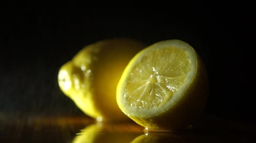 Fresh Juicy Lemon Slice Close Up on Dark