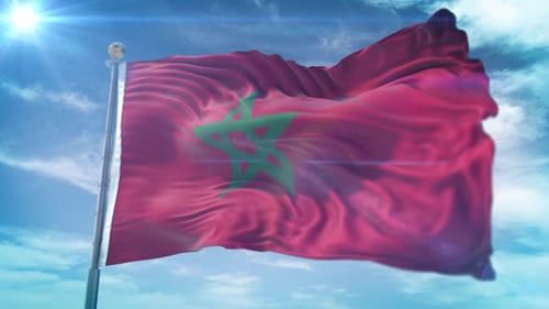 Waving Moroccan National Flag Against Blue Sky